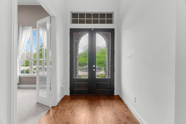 2216 Richmond Park Ln, Prosper, TX 75078 - entryway featuring french doors, baseboards, and wood finished floors