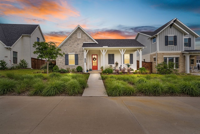 14344 Walsh Ave, Fort Worth, TX 76008 - view of front of home with stone siding, board and batten siding, and covered porch