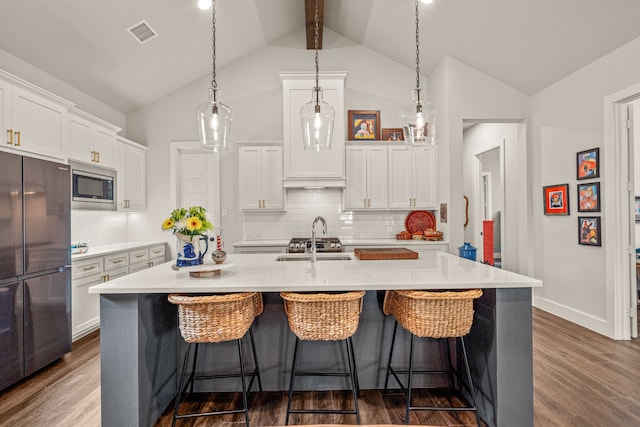 14344 Walsh Ave, Fort Worth, TX 76008 - kitchen featuring freestanding refrigerator, stainless steel microwave, a sink, backsplash, and white cabinets