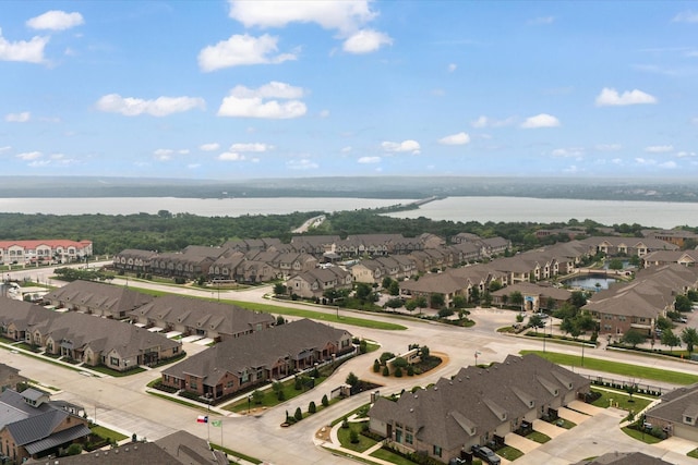 aerial perspective of suburban area with a nearby body of water