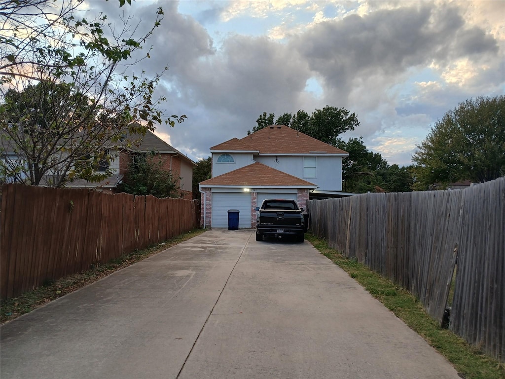 7992 Quest Ct, Frisco, TX 75035 - view of home's exterior with a garage, fence, brick siding, and concrete driveway