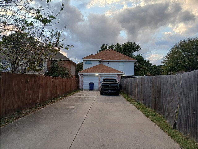 7992 Quest Ct, Frisco, TX 75035 - view of home's exterior with a garage, fence, brick siding, and concrete driveway