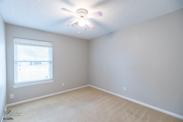 3242 Whitewing Way, Abilene, TX 79606 - empty room featuring a textured ceiling, light carpet, a ceiling fan, and baseboards