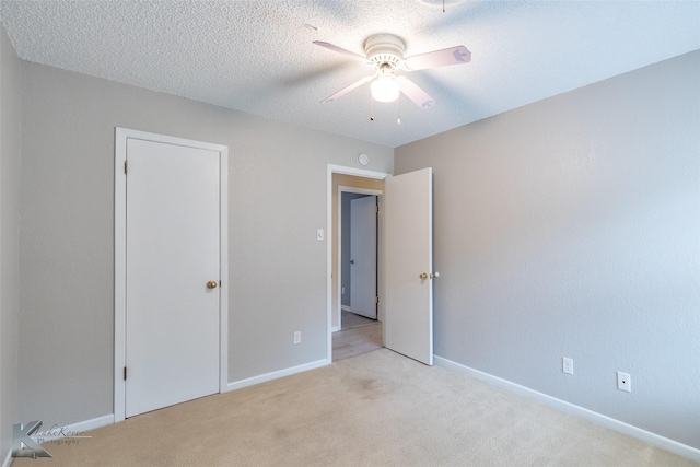 3242 Whitewing Way, Abilene, TX 79606 - unfurnished bedroom with light colored carpet, baseboards, ceiling fan, and a textured ceiling