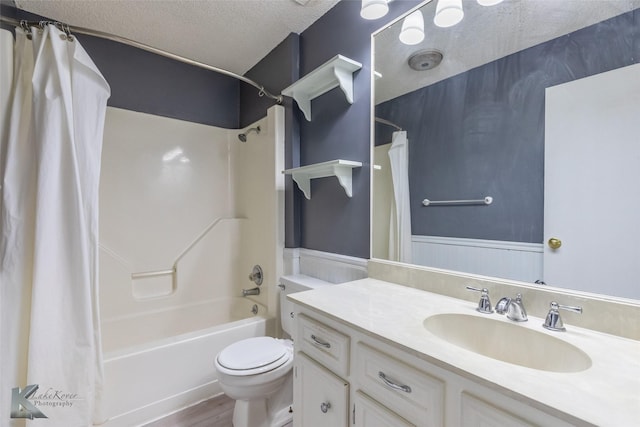 3242 Whitewing Way, Abilene, TX 79606 - bathroom featuring shower / tub combo, vanity, toilet, a textured ceiling, and wood finished floors