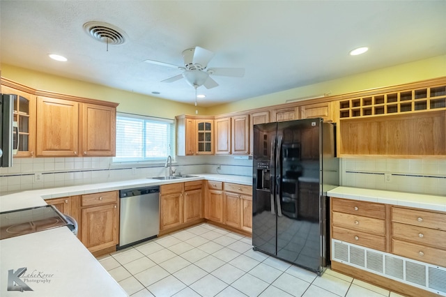 3242 Whitewing Way, Abilene, TX 79606 - kitchen featuring black fridge with ice dispenser, stainless steel dishwasher, a sink, decorative backsplash, and a ceiling fan