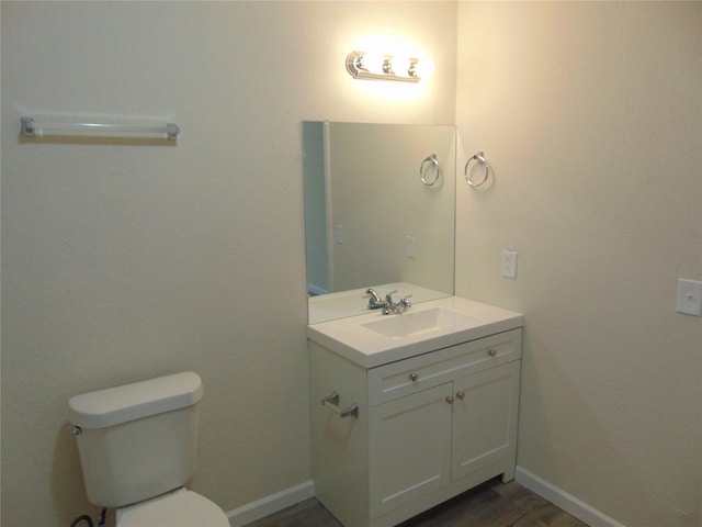 7928 Hull Ave, Dallas, TX 75216 - bathroom with vanity, toilet, and baseboards