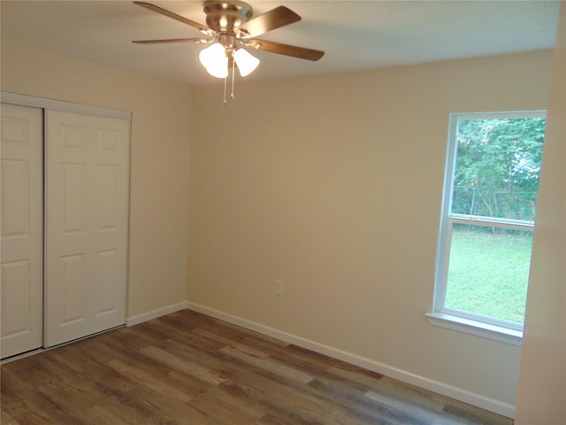 7928 Hull Ave, Dallas, TX 75216 - unfurnished bedroom featuring multiple windows, wood finished floors, and a closet