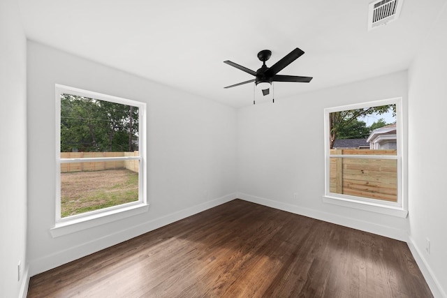 10430 Wood Dale Dr, Dallas, TX 75228 - spare room featuring dark wood-style flooring, baseboards, and a ceiling fan