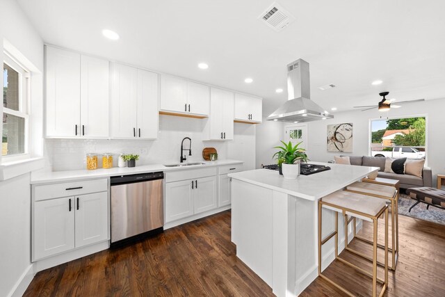10430 Wood Dale Dr, Dallas, TX 75228 - kitchen with stainless steel dishwasher, island exhaust hood, a sink, black gas stovetop, and a breakfast bar area