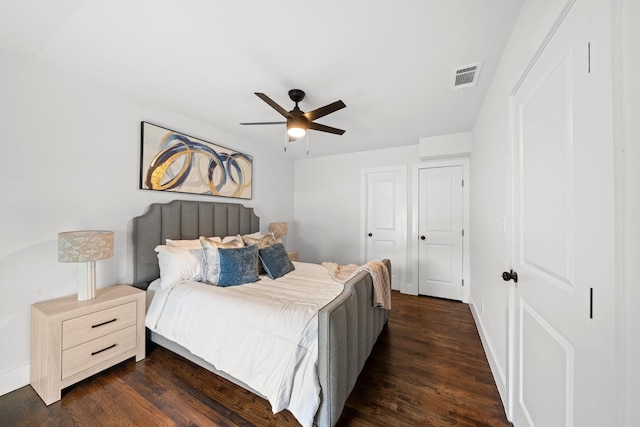 10430 Wood Dale Dr, Dallas, TX 75228 - bedroom with dark wood-style flooring, ceiling fan, and baseboards