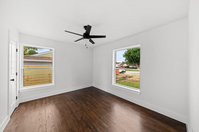 10430 Wood Dale Dr, Dallas, TX 75228 - unfurnished room featuring plenty of natural light, dark wood-style flooring, and baseboards