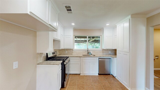 3201 Lakeland St, Fort Worth, TX 76111 - kitchen with appliances with stainless steel finishes, a sink, decorative backsplash, recessed lighting, and light stone counters