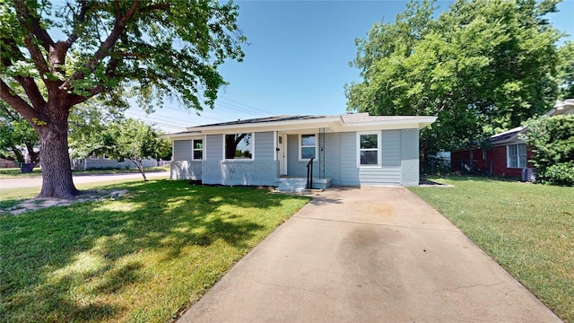 3201 Lakeland St, Fort Worth, TX 76111 - view of front of property featuring a front lawn, brick siding, and concrete driveway