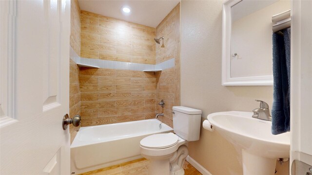 3201 Lakeland St, Fort Worth, TX 76111 - bathroom with toilet, washtub / shower combination, and a sink