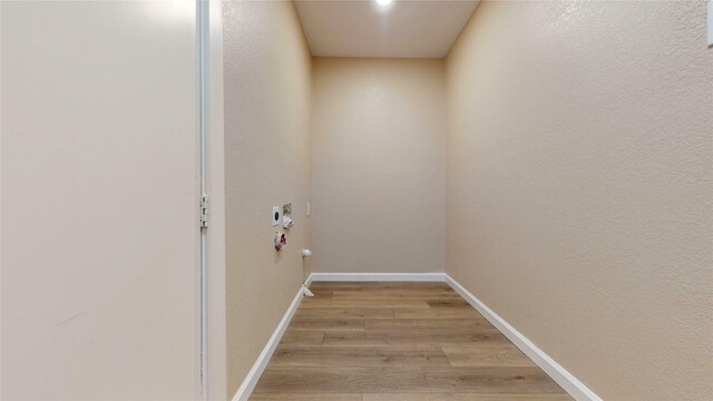 3201 Lakeland St, Fort Worth, TX 76111 - laundry area featuring light wood-style floors and baseboards