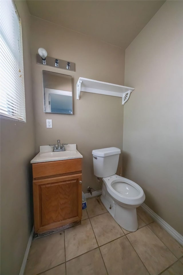 8820 Easley St, White Settlement, TX 76108 - half bath with toilet, tile patterned flooring, vanity, and baseboards