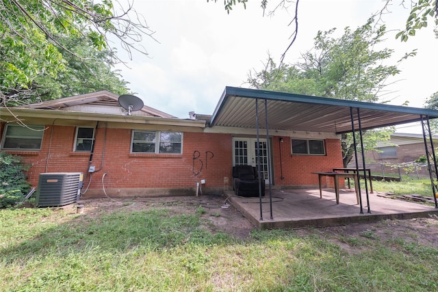 8820 Easley St, White Settlement, TX 76108 - rear view of house with central air condition unit, a patio area, brick siding, and french doors