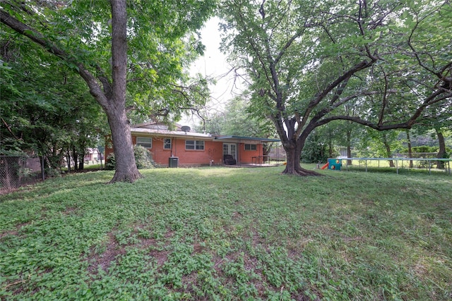 8820 Easley St, White Settlement, TX 76108 - view of yard featuring a trampoline and central air condition unit