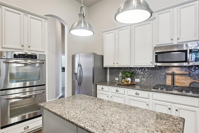 424 Sagewood Ct, Keller, TX 76248 - kitchen featuring appliances with stainless steel finishes, dark stone countertops, backsplash, and white cabinetry
