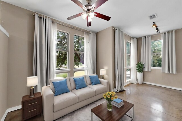 201 W Lancaster Ave Unit 218, Fort Worth, TX 76102 - living room with ceiling fan, plenty of natural light, baseboards, and finished concrete flooring