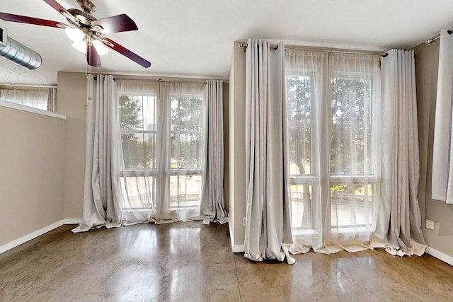 201 W Lancaster Ave Unit 218, Fort Worth, TX 76102 - spare room featuring a ceiling fan, baseboards, and concrete floors