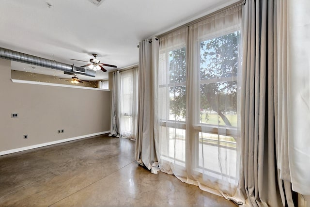 201 W Lancaster Ave Unit 218, Fort Worth, TX 76102 - empty room featuring finished concrete flooring, a ceiling fan, and baseboards