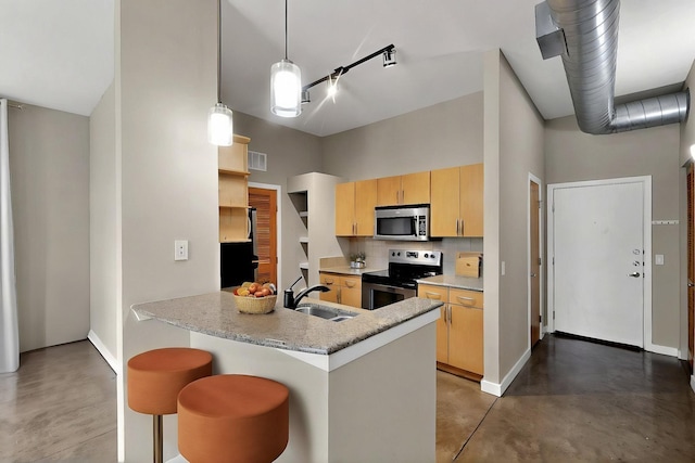 201 W Lancaster Ave Unit 218, Fort Worth, TX 76102 - kitchen featuring appliances with stainless steel finishes, a sink, finished concrete flooring, tasteful backsplash, and baseboards