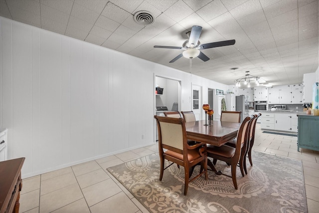 4900 Ira St, Haltom City, TX 76117 - dining room with a ceiling fan, light tile patterned flooring, and baseboards
