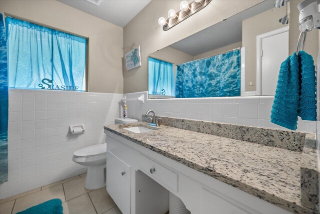 4900 Ira St, Haltom City, TX 76117 - full bathroom with tile walls, tile patterned floors, toilet, vanity, and curtained shower