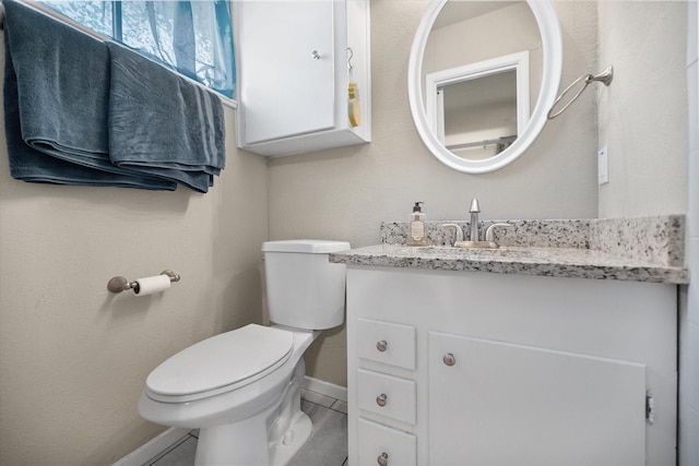 4900 Ira St, Haltom City, TX 76117 - bathroom with baseboards, toilet, and vanity