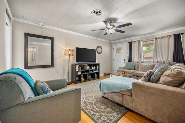 4900 Ira St, Haltom City, TX 76117 - living room featuring wood finished floors, ceiling fan, and ornamental molding