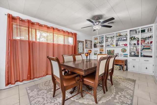4900 Ira St, Haltom City, TX 76117 - dining area with light tile patterned floors, a ceiling fan, and built in shelves