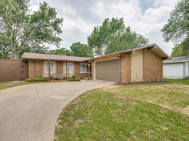 827 Sherbrook Dr, Richardson, TX 75080 - view of front of property with an attached garage, brick siding, concrete driveway, and a front lawn
