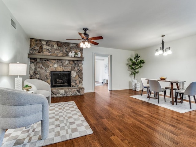 827 Sherbrook Dr, Richardson, TX 75080 - living area with a fireplace, wood finished floors, a ceiling fan, a chandelier, and baseboards
