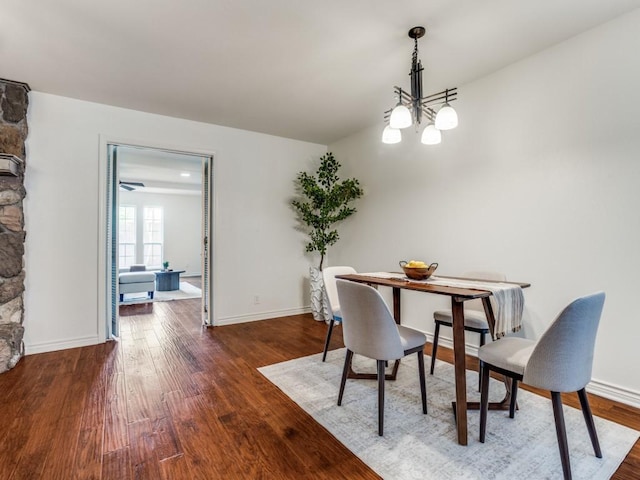 827 Sherbrook Dr, Richardson, TX 75080 - dining space featuring wood finished floors, a chandelier, and baseboards