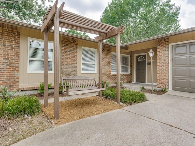 827 Sherbrook Dr, Richardson, TX 75080 - doorway to property with brick siding, a garage, a pergola, and concrete driveway