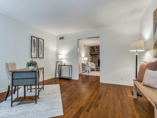827 Sherbrook Dr, Richardson, TX 75080 - office area featuring wood finished floors, a stone fireplace, and baseboards