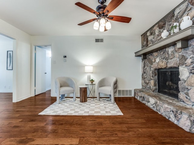827 Sherbrook Dr, Richardson, TX 75080 - living area with wood finished floors, a ceiling fan, a stone fireplace, and baseboards