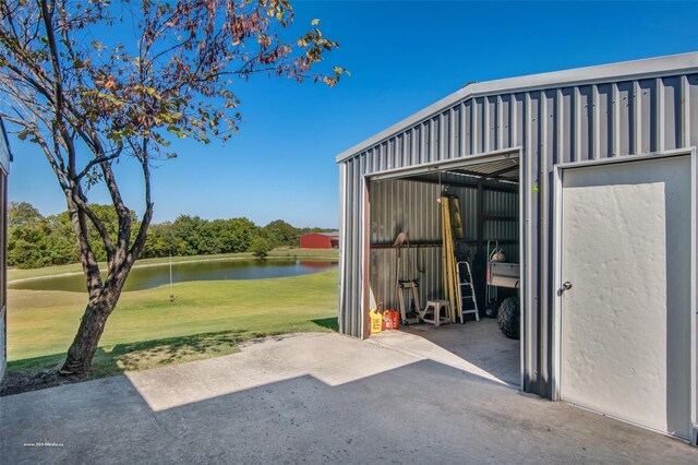 930 Lakeridge Dr, Lavon, TX 75166 - view of patio / terrace with a water view, an outbuilding, and golf course view