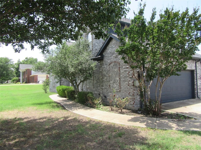 930 Lakeridge Dr, Lavon, TX 75166 - view of side of property featuring a lawn, concrete driveway, brick siding, and an attached garage