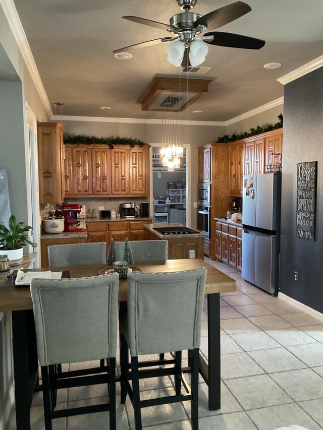 930 Lakeridge Dr, Lavon, TX 75166 - kitchen featuring freestanding refrigerator, brown cabinetry, a center island, a ceiling fan, and black electric cooktop
