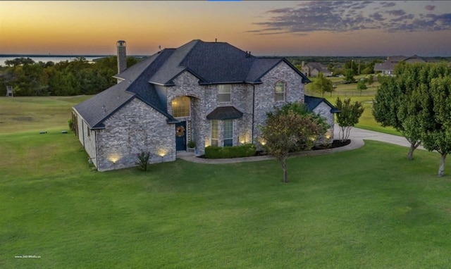930 Lakeridge Dr, Lavon, TX 75166 - french country style house featuring stone siding, a yard, and a chimney