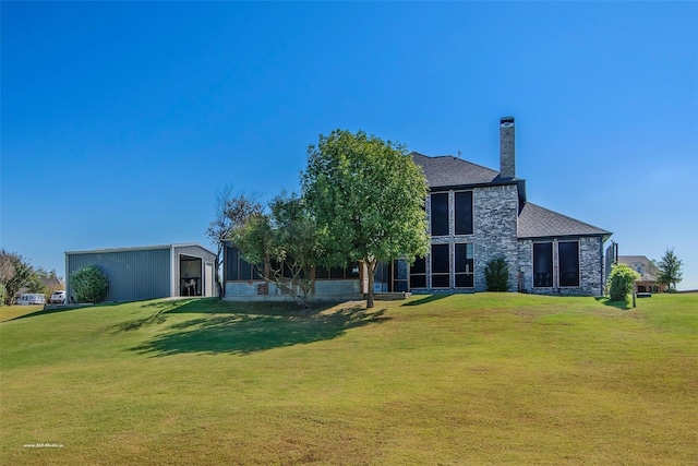 930 Lakeridge Dr, Lavon, TX 75166 - back of property featuring a lawn, an outbuilding, a detached garage, and a chimney