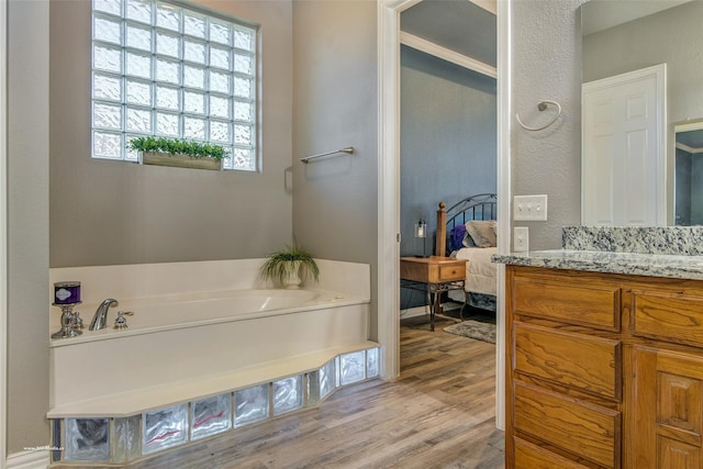 930 Lakeridge Dr, Lavon, TX 75166 - full bath featuring vanity, a garden tub, wood finished floors, ensuite bath, and a textured wall