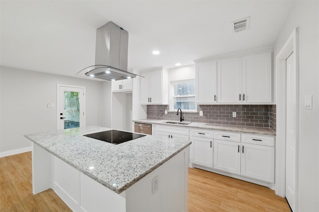 742 Chalk Hill Ln, Desoto, TX 75115 - kitchen with island range hood, black electric stovetop, a sink, light wood-type flooring, and recessed lighting
