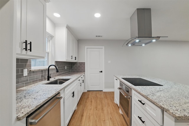 742 Chalk Hill Ln, Desoto, TX 75115 - kitchen featuring appliances with stainless steel finishes, a sink, island exhaust hood, light wood-type flooring, and backsplash