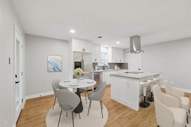 742 Chalk Hill Ln, Desoto, TX 75115 - kitchen with ventilation hood, appliances with stainless steel finishes, light wood-style flooring, white cabinets, and recessed lighting