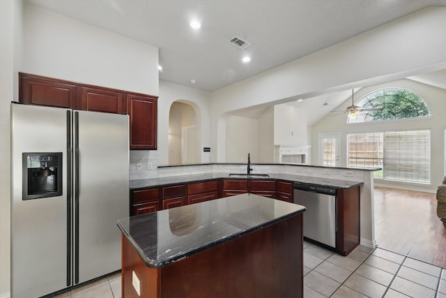 8100 Hosta Way, Fort Worth, TX 76123 - kitchen with stainless steel appliances, a sink, reddish brown cabinets, a ceiling fan, and lofted ceiling