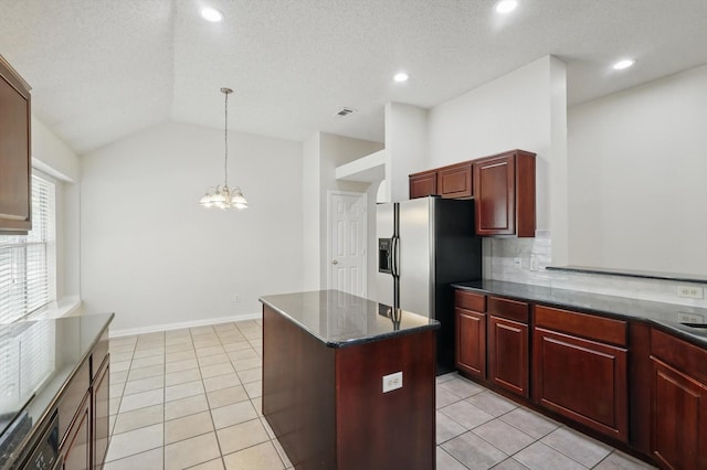8100 Hosta Way, Fort Worth, TX 76123 - kitchen featuring dark brown cabinets, a chandelier, a kitchen island, vaulted ceiling, and pendant lighting